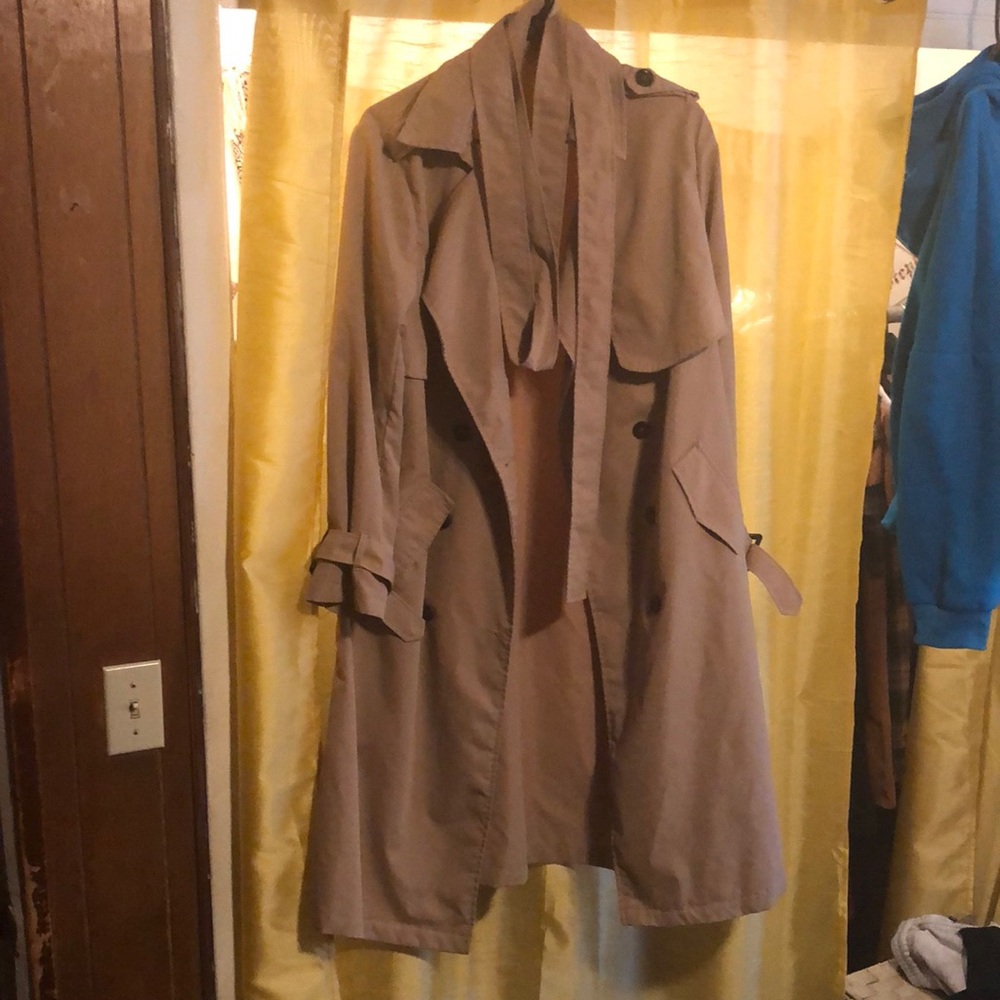 Tan trench coat with belt and cuff straps